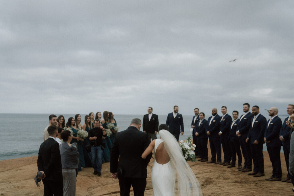 father walking bride down aisle during sunrise ceremony in california