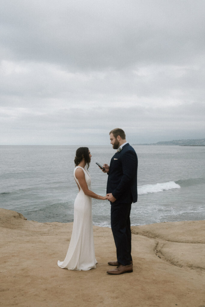 bride and groom exchange private vows on sunset cliff in san diego