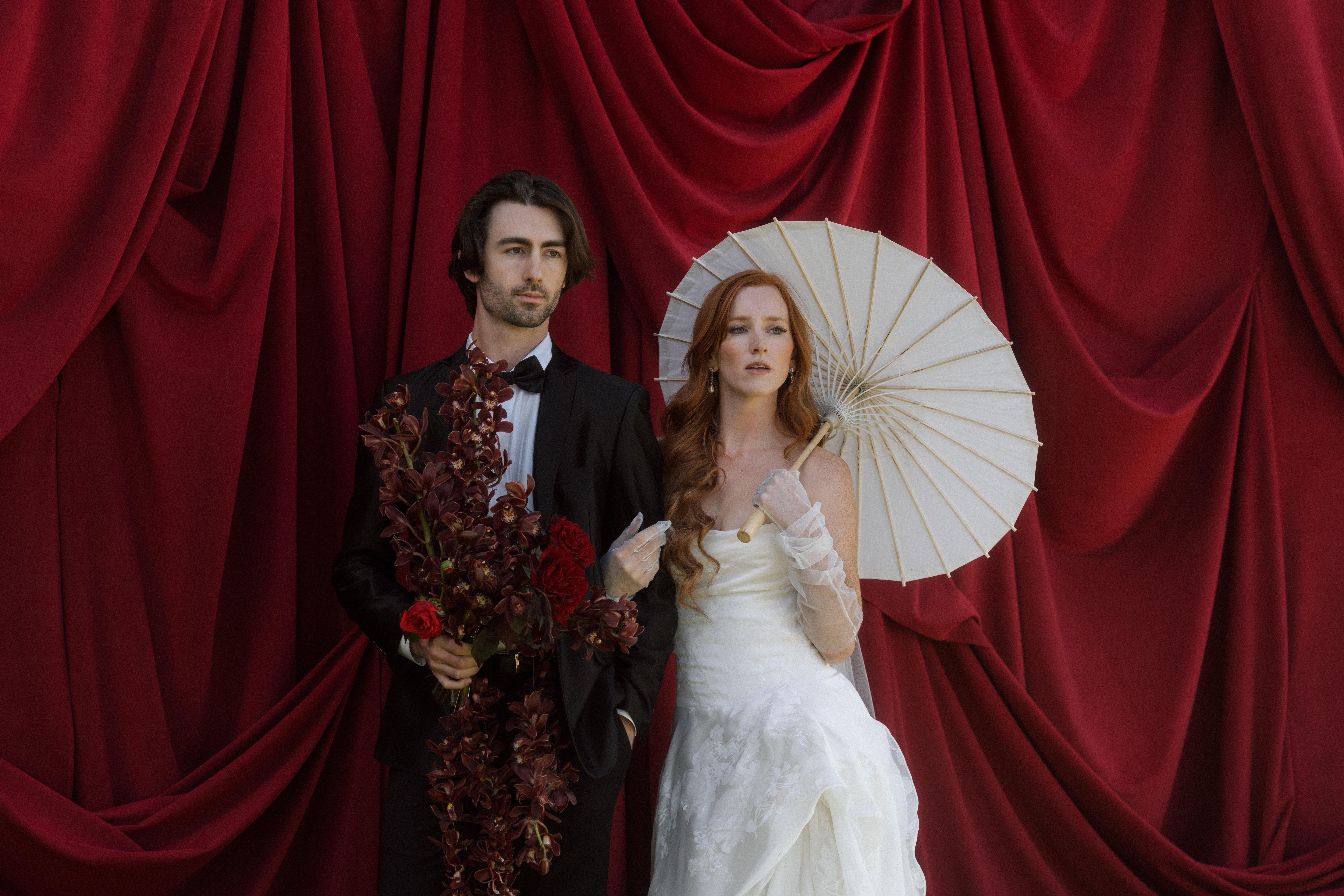Bride and groom standing in front of Greystone Castle in Boulder, Colorado, surrounded by draped fabric