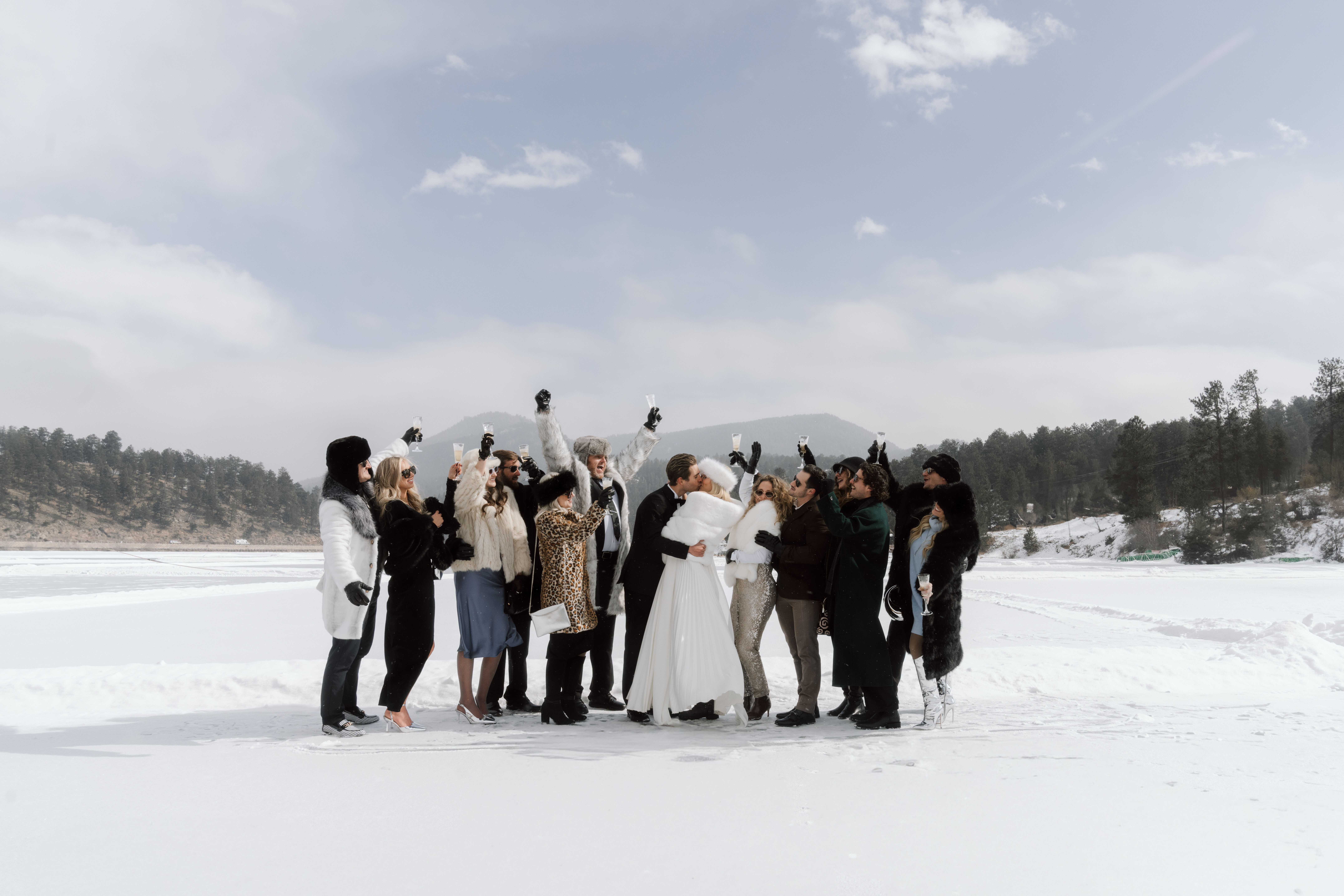Winter Wedding guests gathered around bride and groom