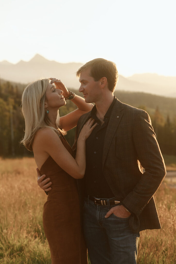 Bride and grown in western attire for their rehearsal dinner posing in golden hour light