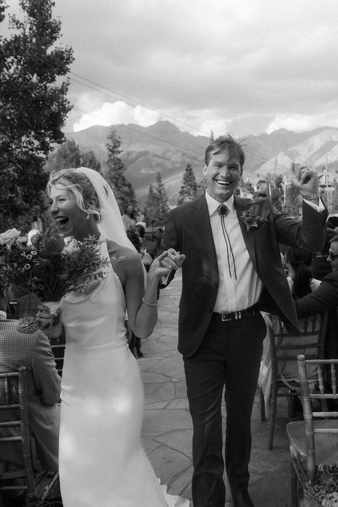 bride and groom walking back up the aisle after saying "i-do"